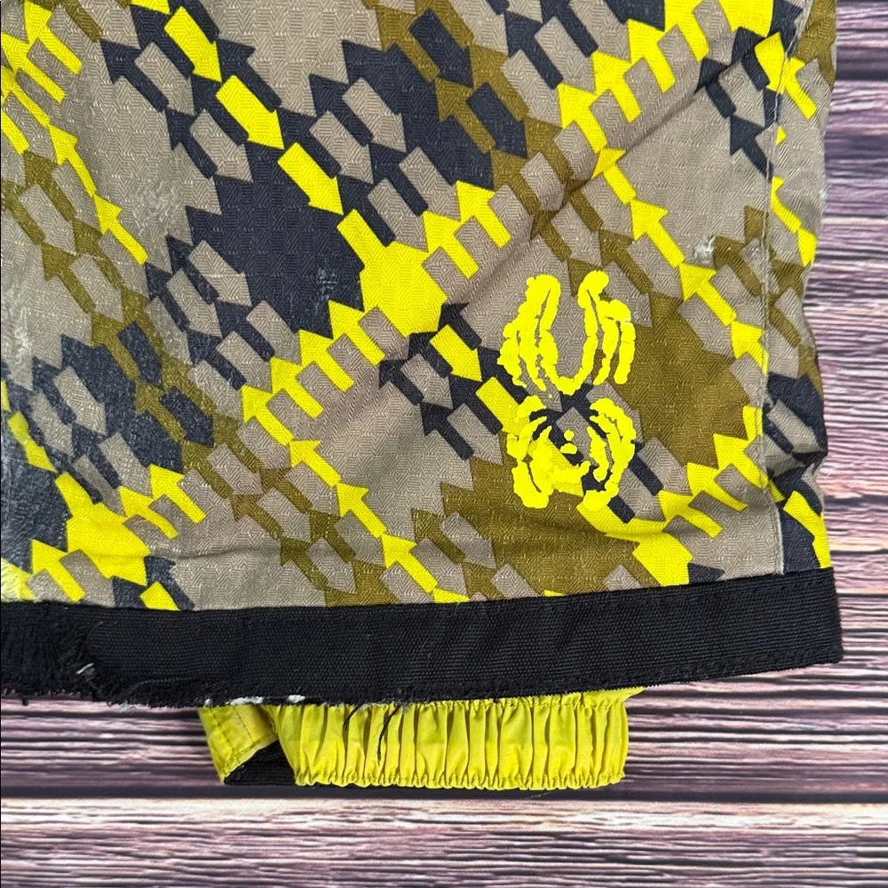 SPYDER Boys' Propulsion ski pants with an olive, black, and yellow plaid pattern